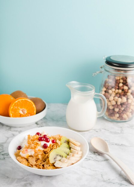 High angle cornflakes with yogurt and fruits