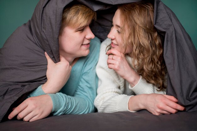 High angle couple covered with blanket