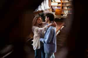 Free photo high angle couple having a bookstore date