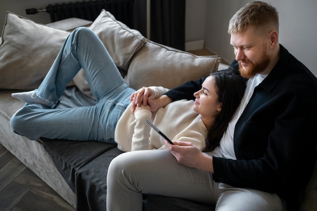 High angle couple laying on couch