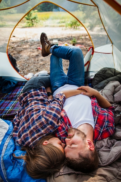 Free Photo high angle couple relaxing in tent