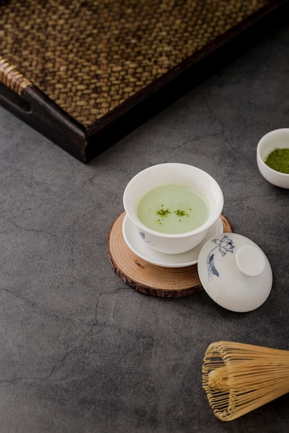 Free photo high angle of cup of matcha tea with tray