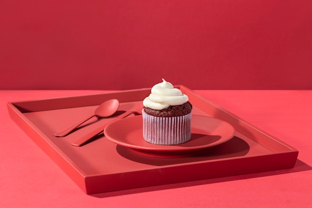 High angle cupcake with cream on plate