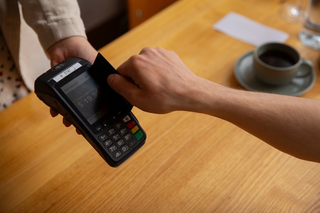 Free Photo high angle customer paying with nfc device