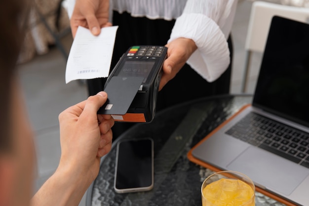 High angle customer paying with nfc device