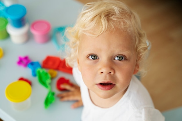 Free photo high angle cute blonde kid indoors