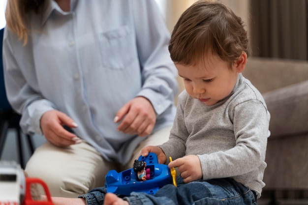 High angle cute kid playing with toy