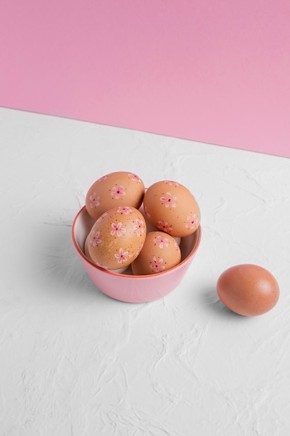 High angle of decorated easter eggs in bowl on the table