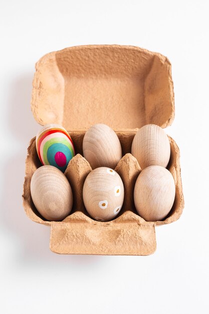 High angle of decorated easter eggs in carton