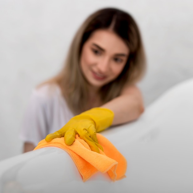 Free photo high angle of defocused woman cleaning surface