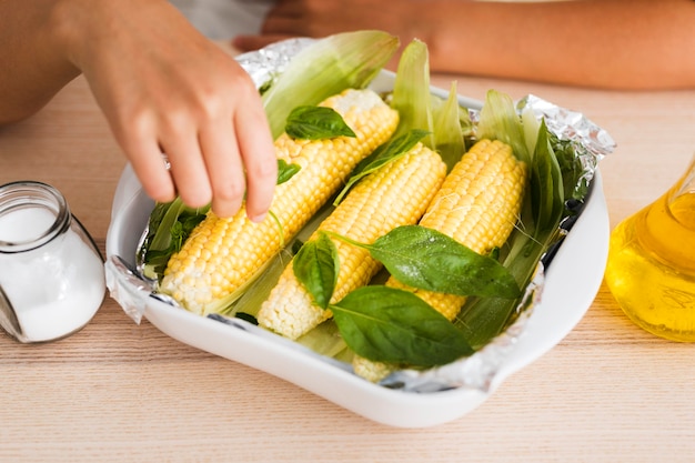 High angle of delicious corn on wooden table