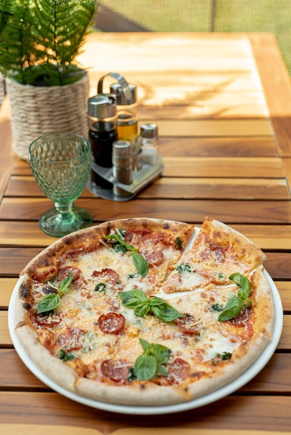 High angle of delicious pizza on wooden table