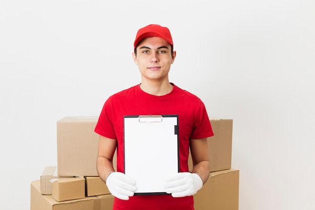 High angle delivery man showing clipboard