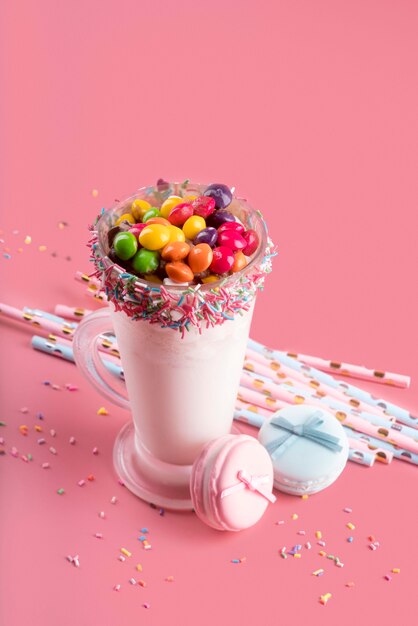 High angle of dessert with colorful candy and straws