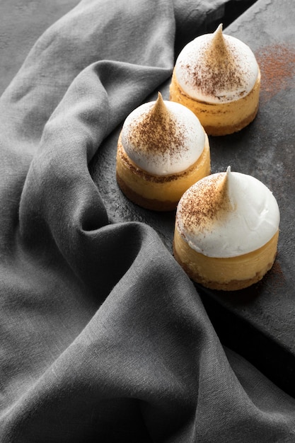 High angle of desserts with cocoa powder and textile