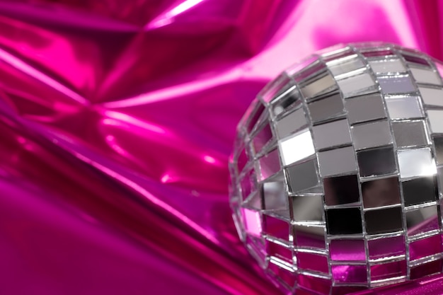 High angle disco globe on pink paper