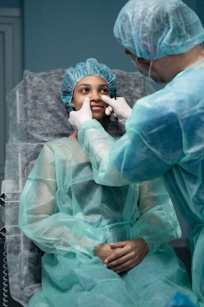 High angle doctor checking patient before rhinoplasty