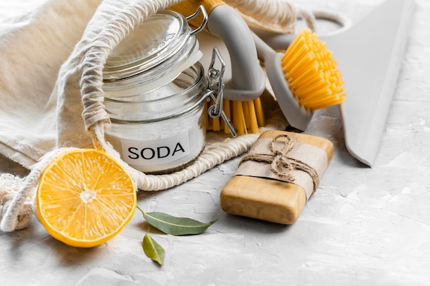 Free photo high angle of eco-friendly cleaning brushes with lemon and baking soda