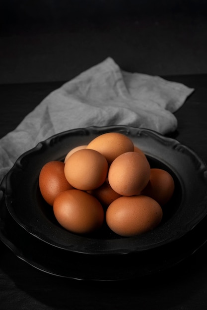 Free photo high angle eggs in bowl with kitchen towel