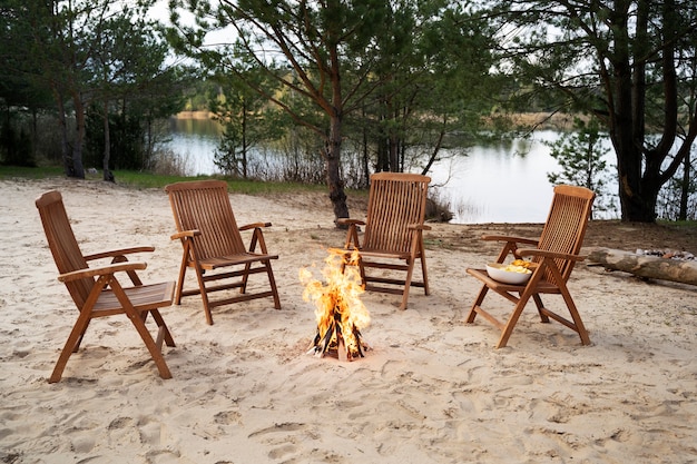 Free photo high angle empty chairs around bonfire