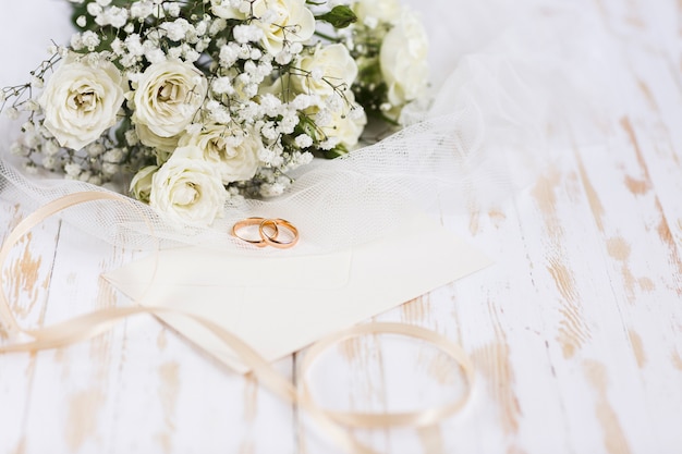 Free photo high angle engagement rings beside flowers