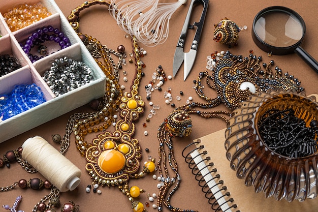 Free photo high angle of essentials for bead working with scissors and thread