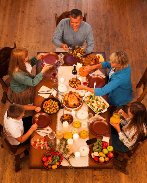 High angle family sitting at dinner table