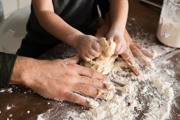 High angle father and son making dough