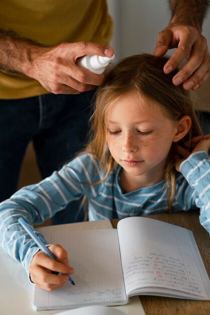 High angle father using lice treatment