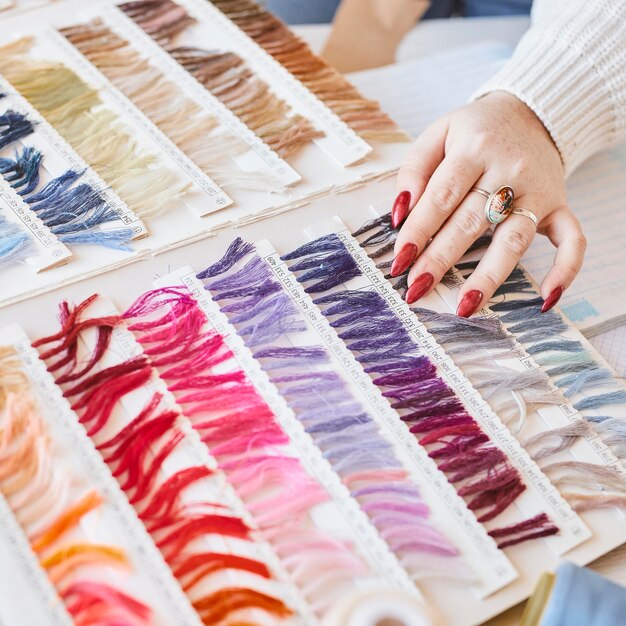 Free Photo high angle of female fashion designer working in atelier with color palette