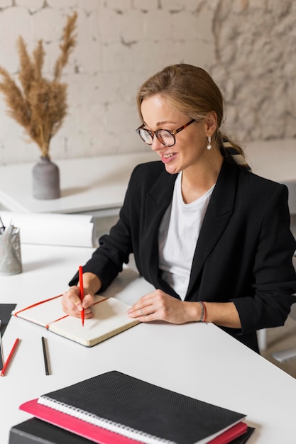 High angle female teacher taking notes