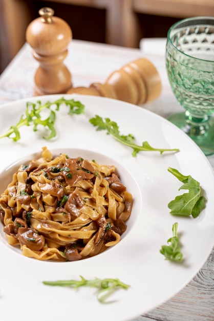 High angle of fettuccine pasta on wooden table