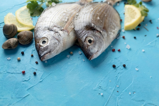 High angle of fish with lemon slices and clams