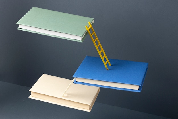 Free photo high angle of floating books connected by ladders for education day