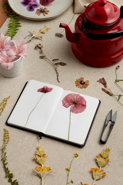 Free Photo high angle flower press with notebook