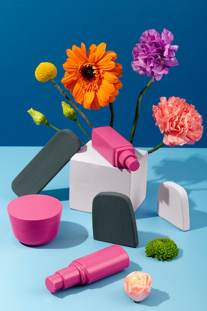 Free Photo high angle flowers and cosmetics containers