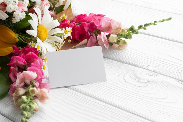 High angle of flowers with blank card