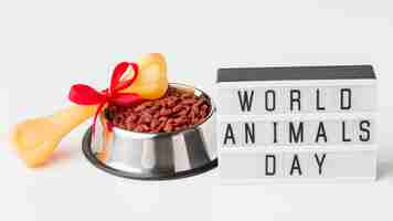 Free photo high angle of food bowl with bone and light box for animal day