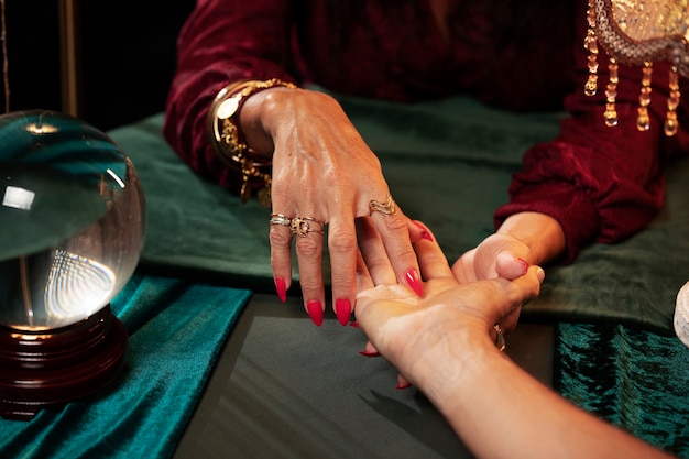 High angle fortune teller palm reading