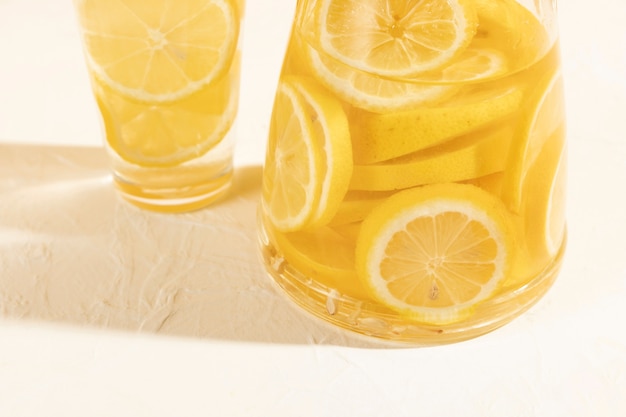 Free Photo high angle fresh lemon slices in glass with lemonade