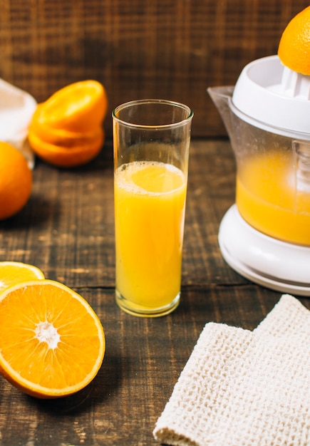 Free Photo high angle fresh orange juice made with manual juicer 