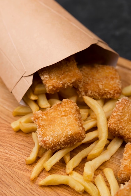 High angle of fried chicken with french fries and paper bag