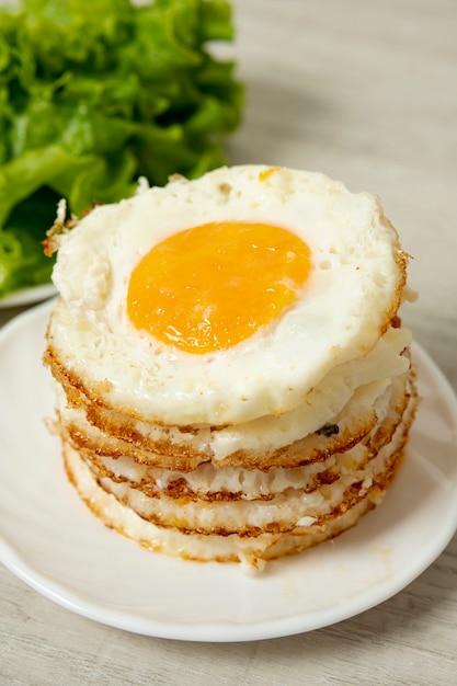 High angle fried eggs arrangement on plain background