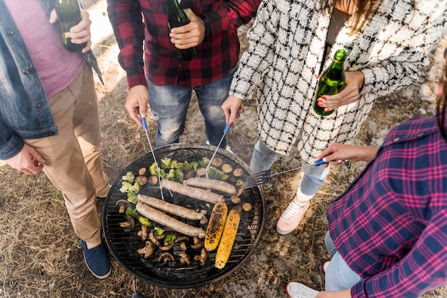 Free photo high angle of friends having a barbecue with beers