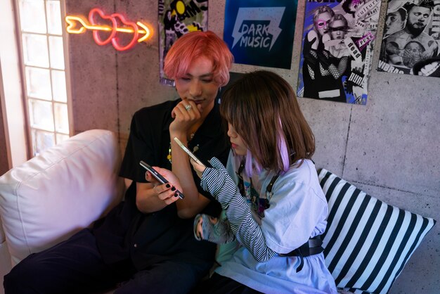 High angle friends holding smartphones