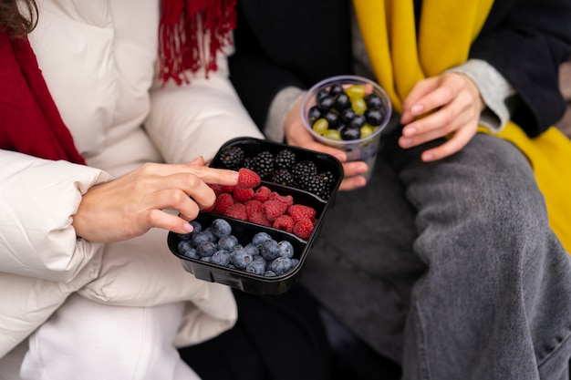 High angle friends with delicious berries