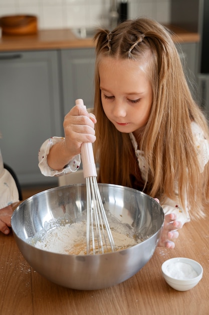 Free Photo high angle girl cooking at home