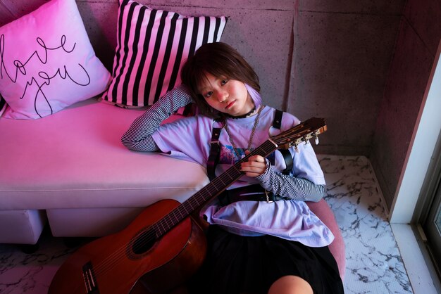 High angle girl holding guitar