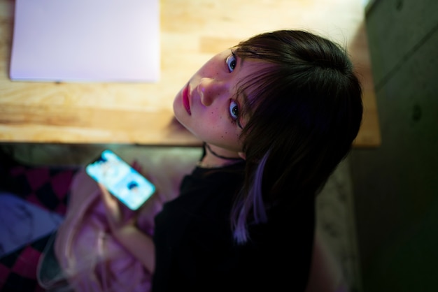 High angle girl holding smartphone