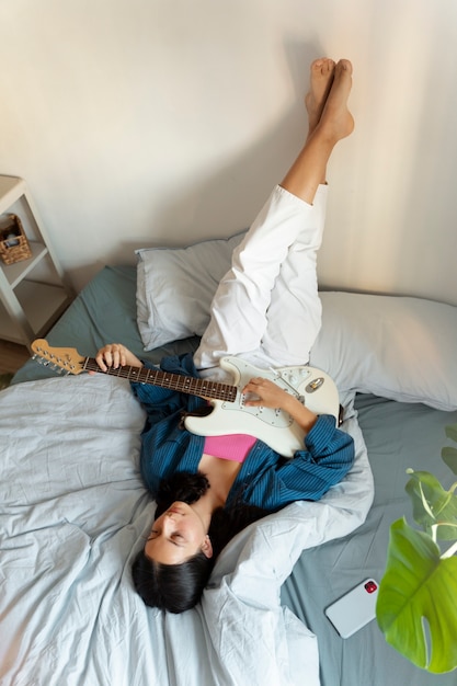 High angle girl making music indoors